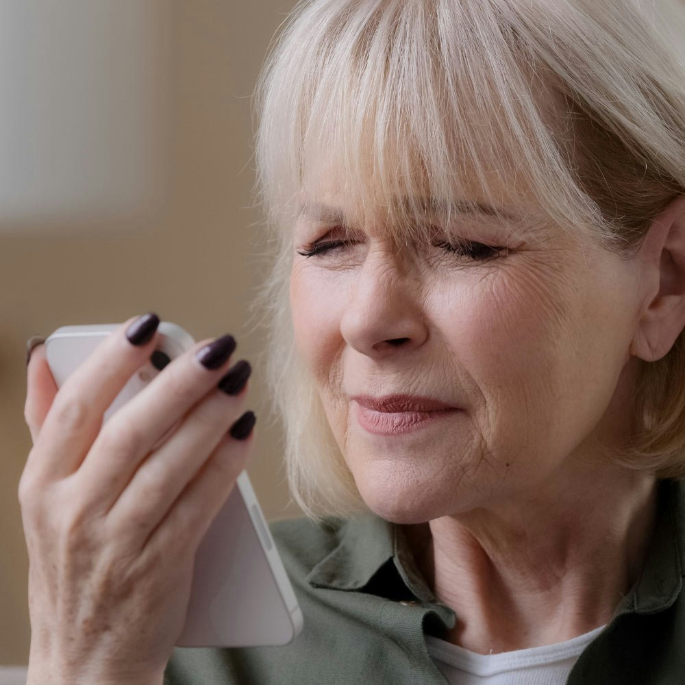 Mature woman squinting at phone