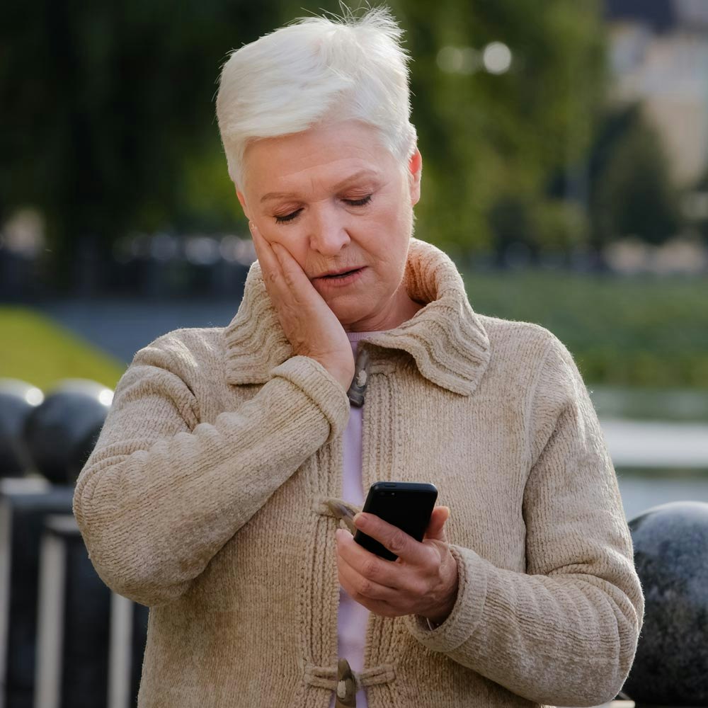 Woman having a hard time reading phone