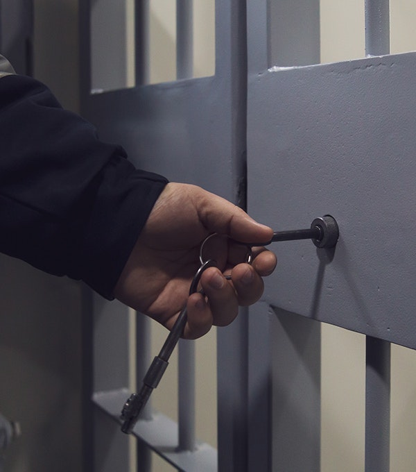 Officer unlocking jail cell door