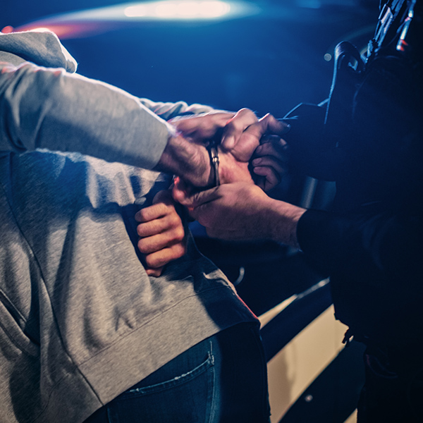 man being handcuffed by police officer