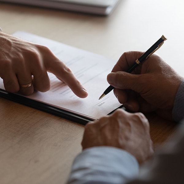 man signing paperwork