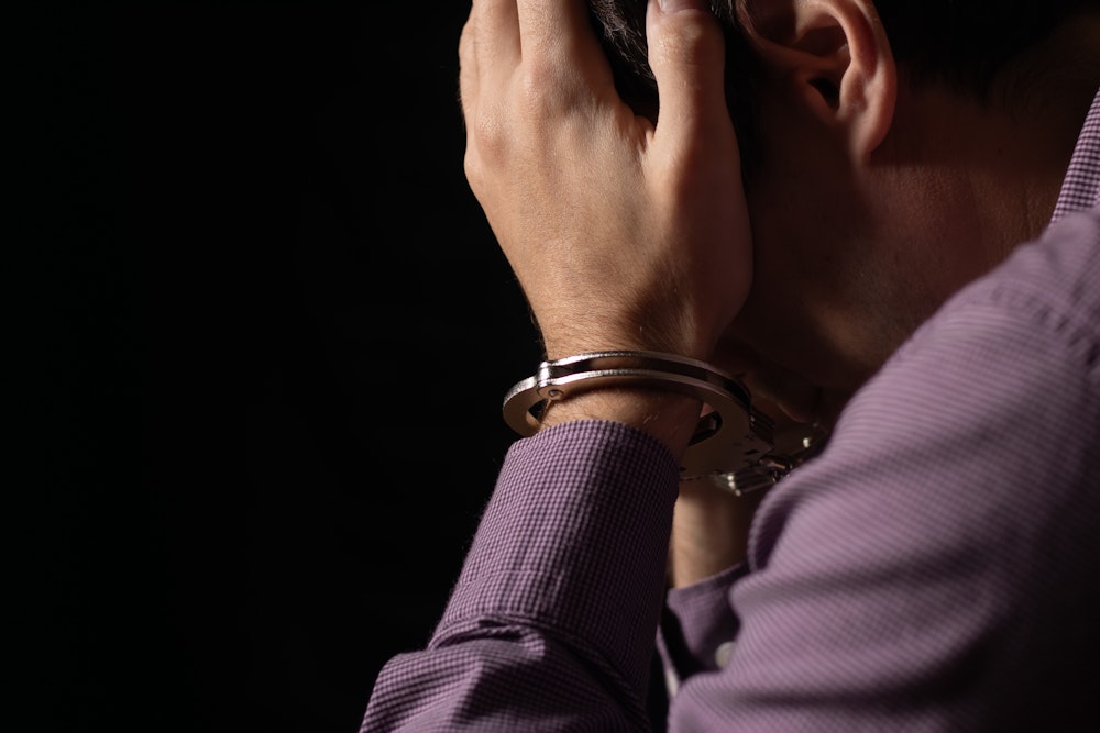 Sad person in handcuffs