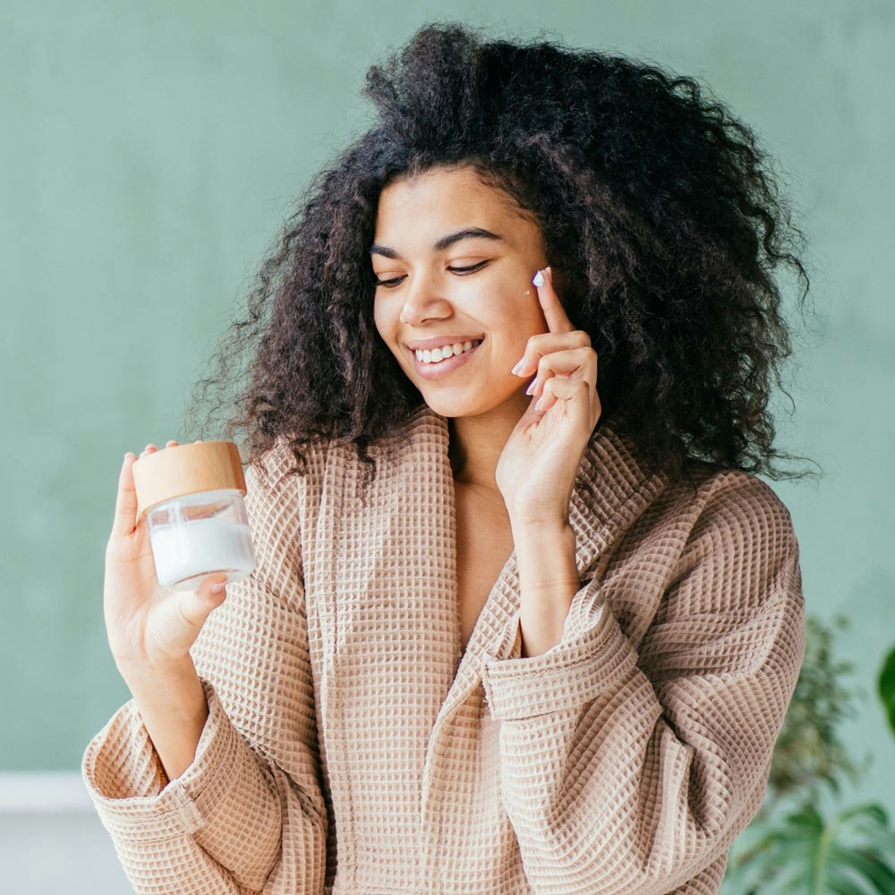 Woman with skincare products