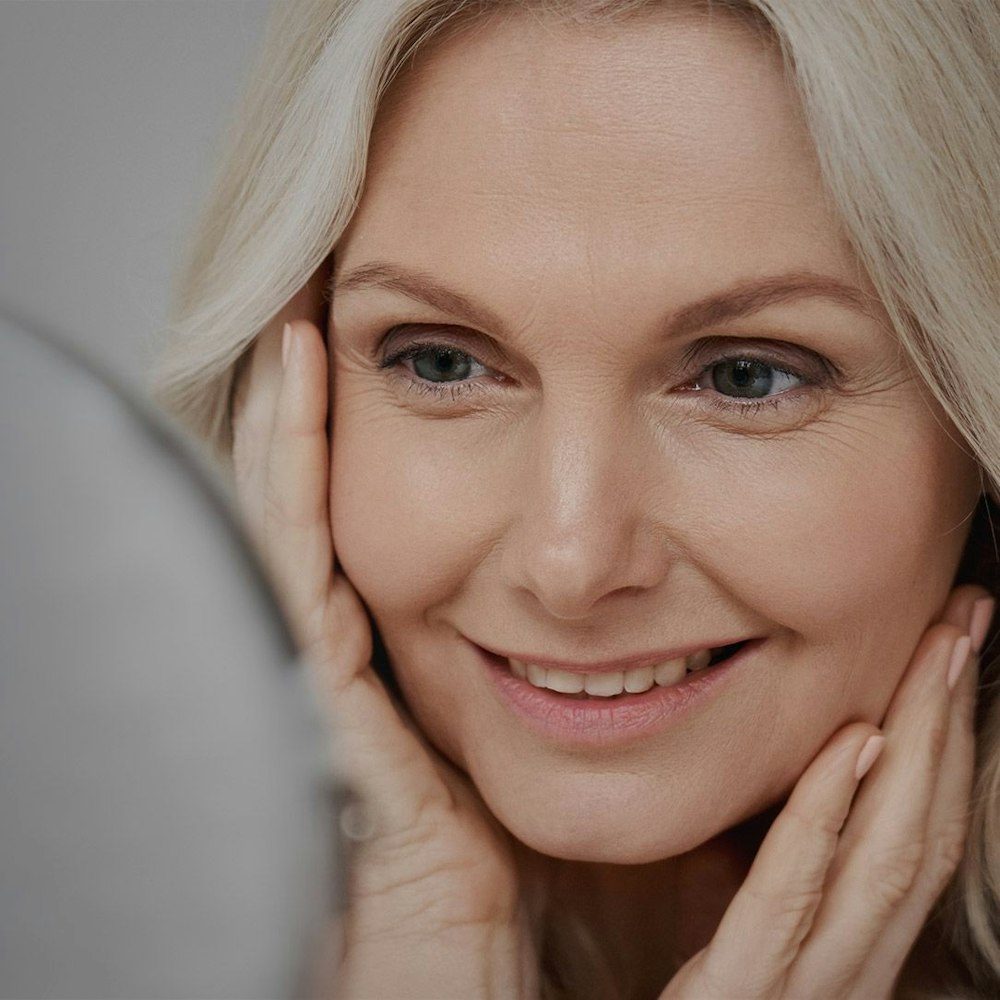woman looking at herself in the mirror