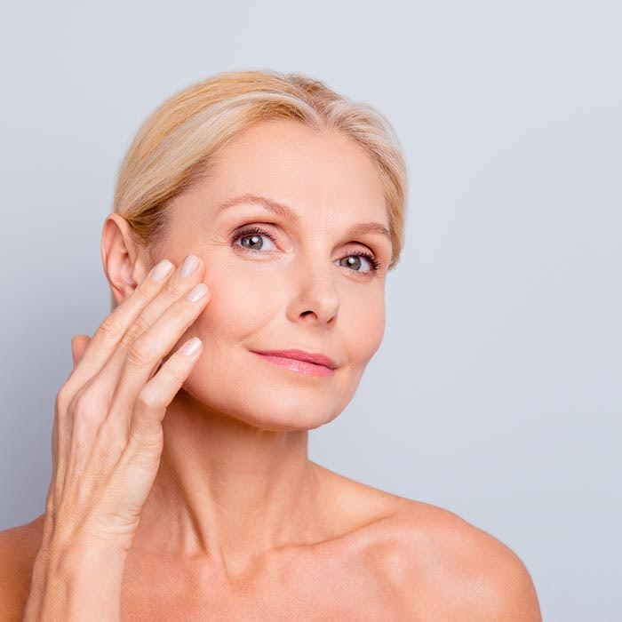 woman with hand on face