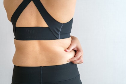 Woman pinching midsection