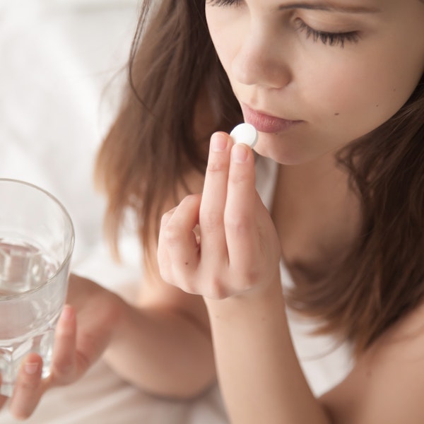 Woman taking oral medication