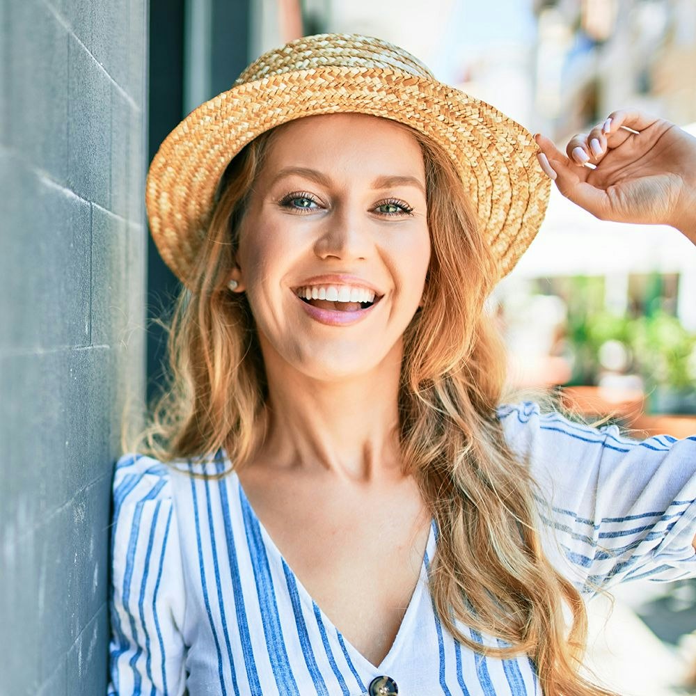 Woman smiling after Teeth Whitening procedure