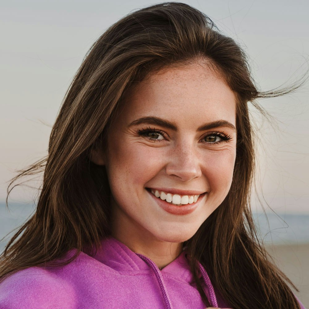 Smiling young woman after cosmetic dentistry