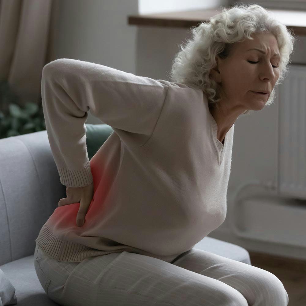 Older woman holding back in pain