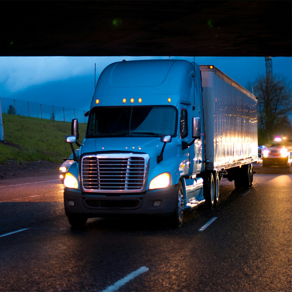 Semi-trailer truck driving at night