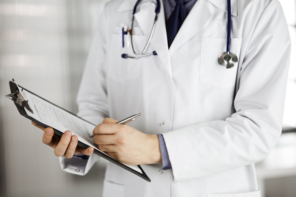 Doctor writing on board