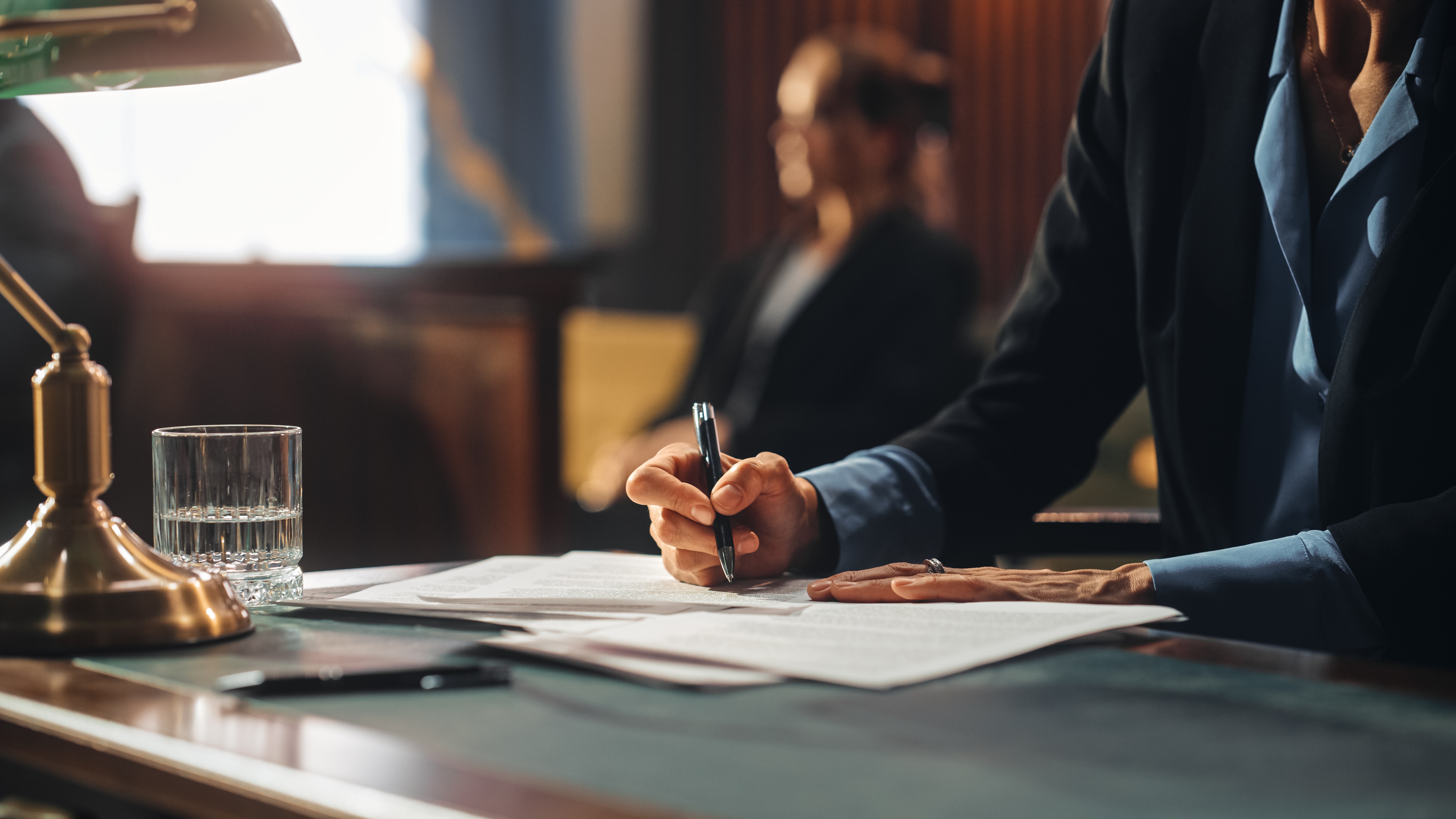 Close-up of a lawyer taking notes in court