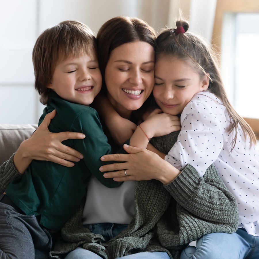 Mother hugging two children