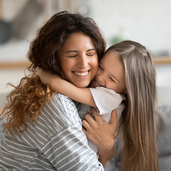 mother hugging her young daughter