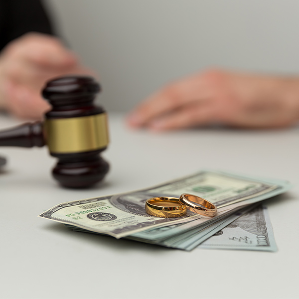 Gavel, cash, and wedding rings