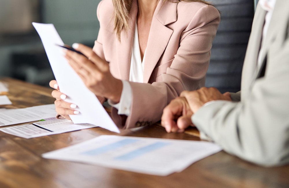 Attorney gesturing at paperwork