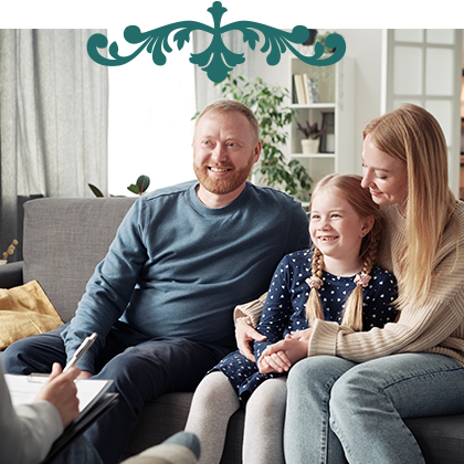 Parents and daughter sitting on couch