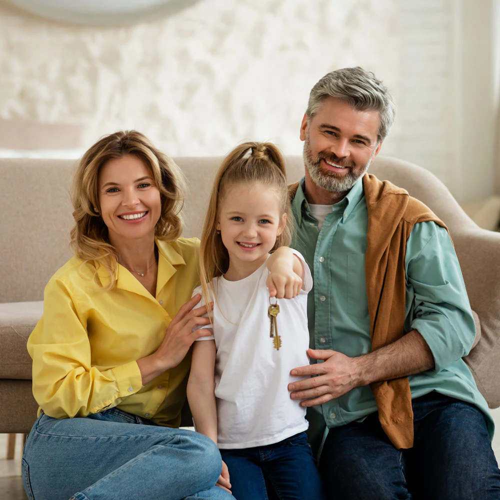 A family with daughter holding house keys