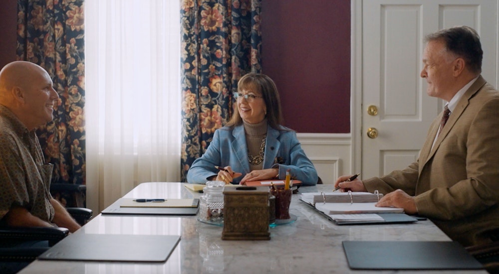 Debra J. Sutton and Matthew J. Kovschak meeting with a client at a conference table