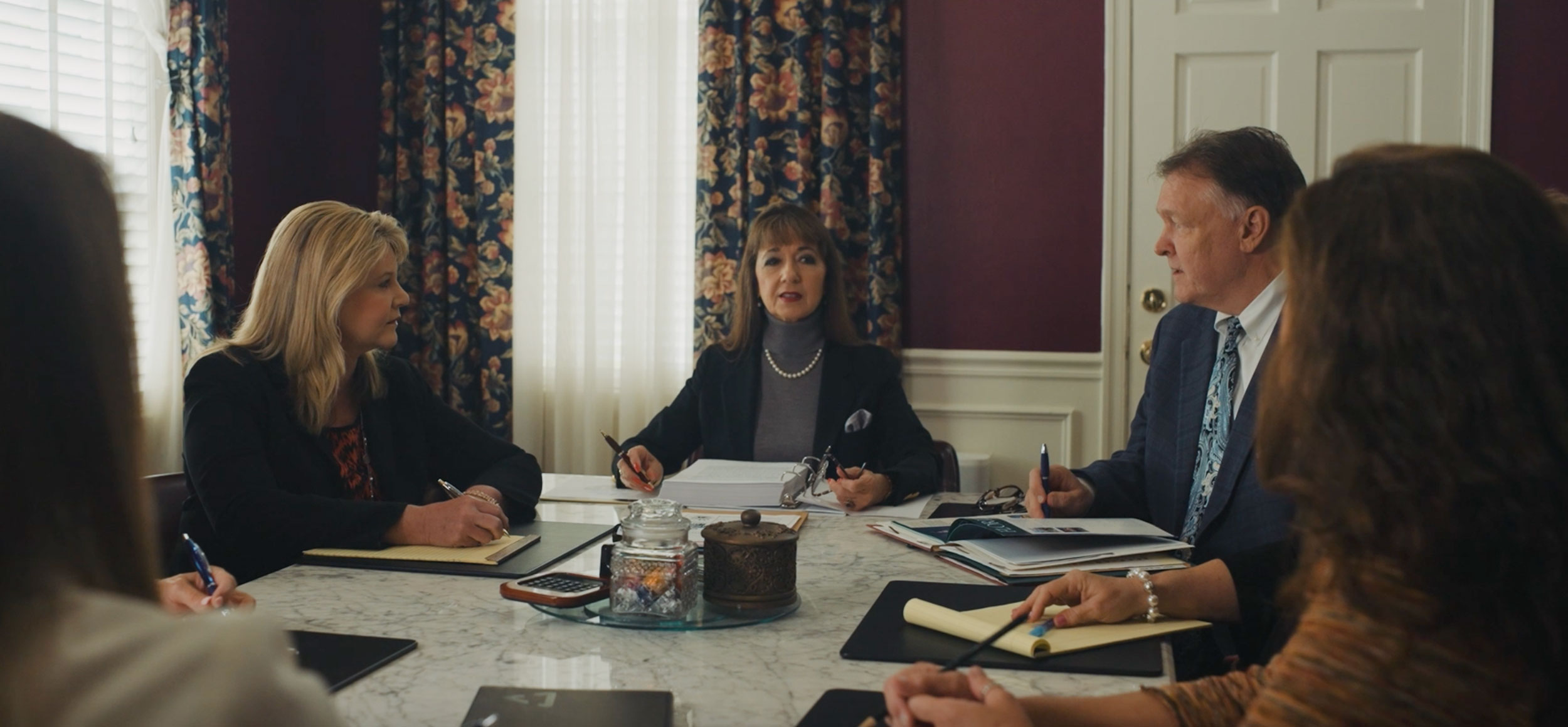 Attorneys Matthew J. Kovschak and Debra Sutton meeting with a client