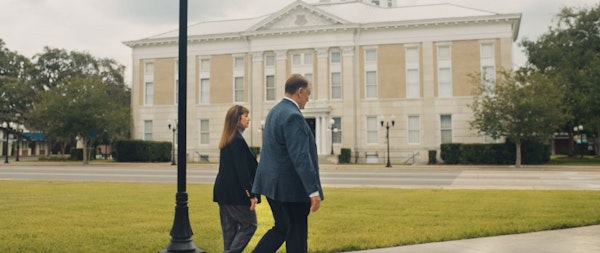Debra J. Sutton and Matthew J. Kovschak walking and talking outside a government building