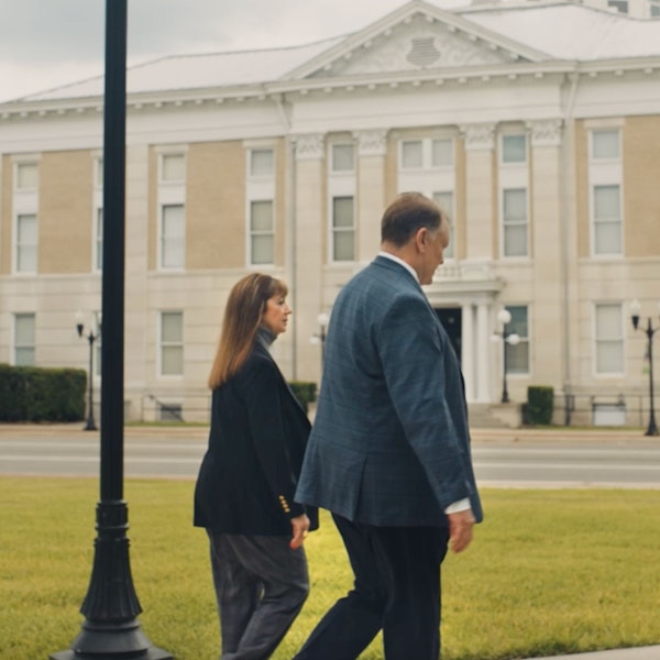 Debra J. Sutton and Matthew J. Kovschak walking and talking outside a government building