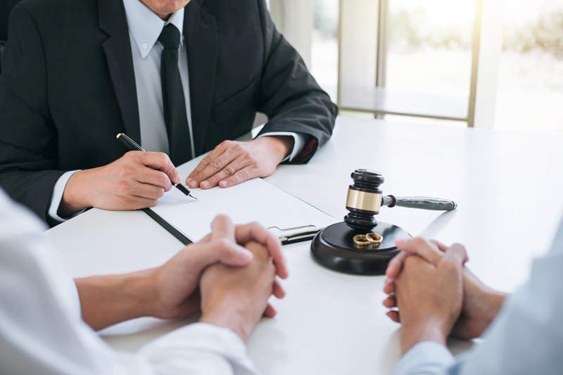 Attorney going over contract with two people