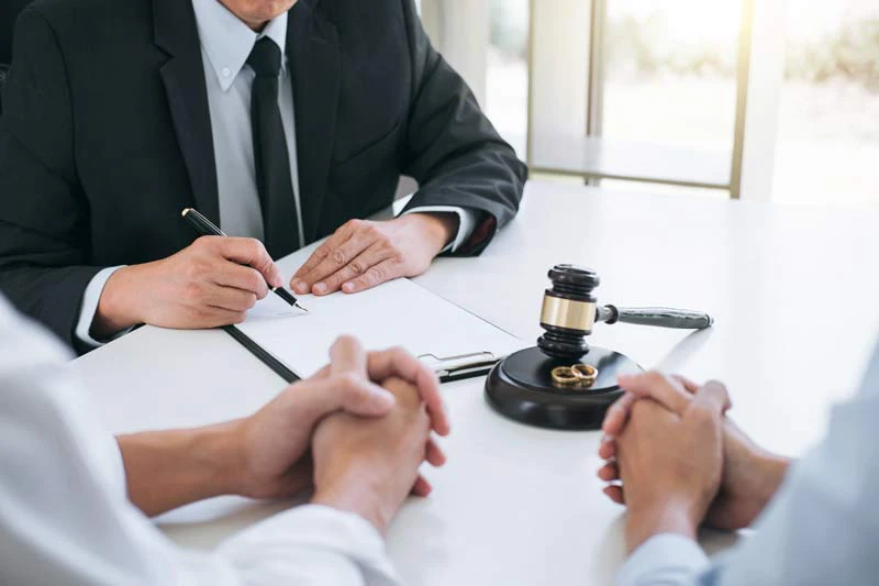 Attorney going over contract with two people