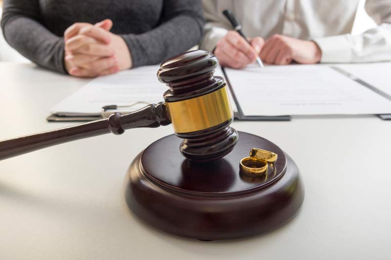 gavel with wedding rings on it