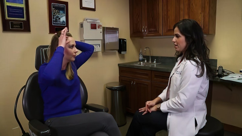 Woman checking hair with doctor