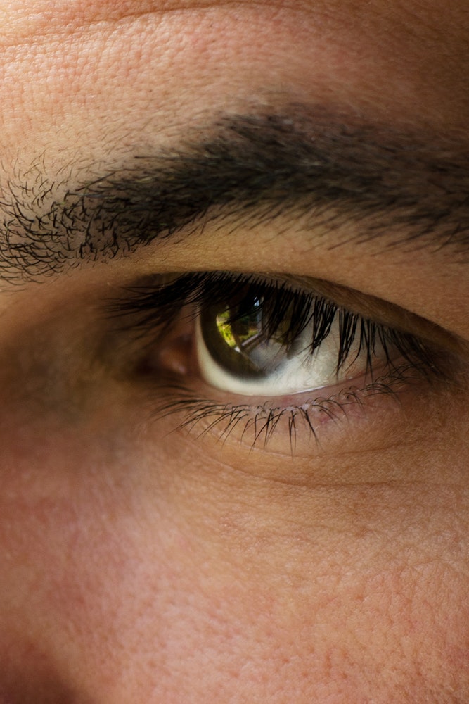 an up close image of a man's eye and eyebrow