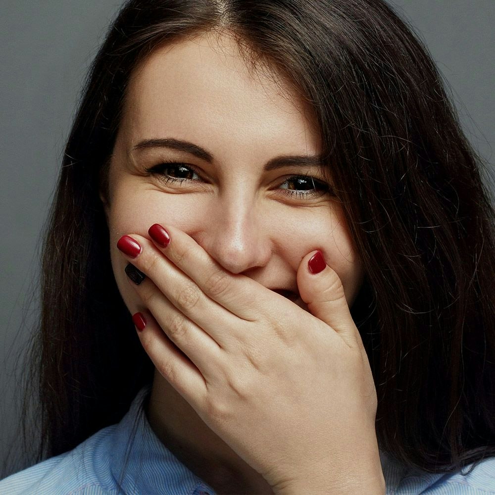 Woman covering mouth with hand