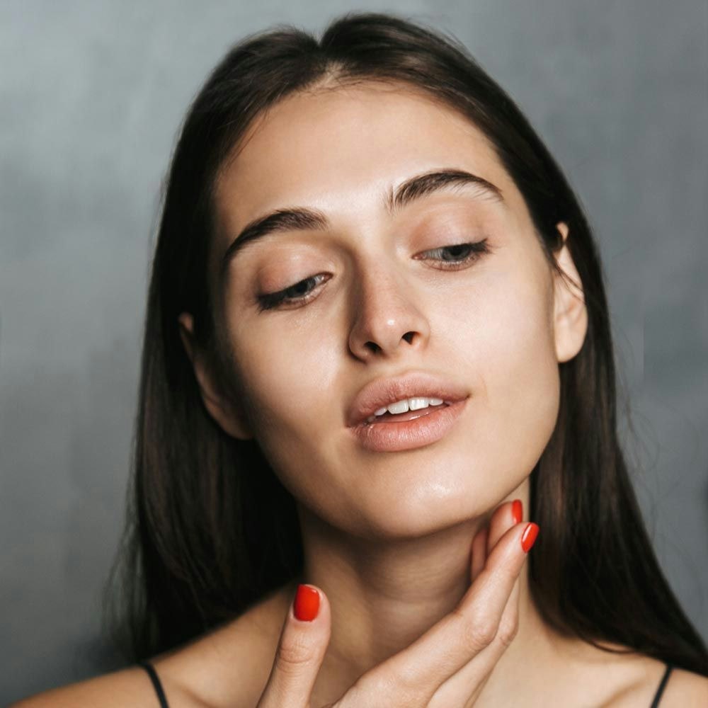 Woman touching her new facelift