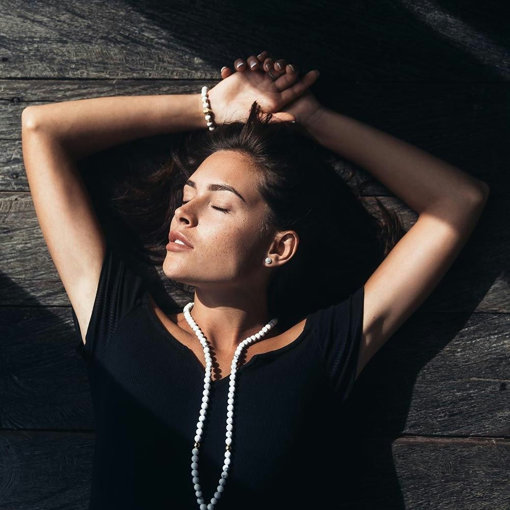 Woman lying down with her arms up