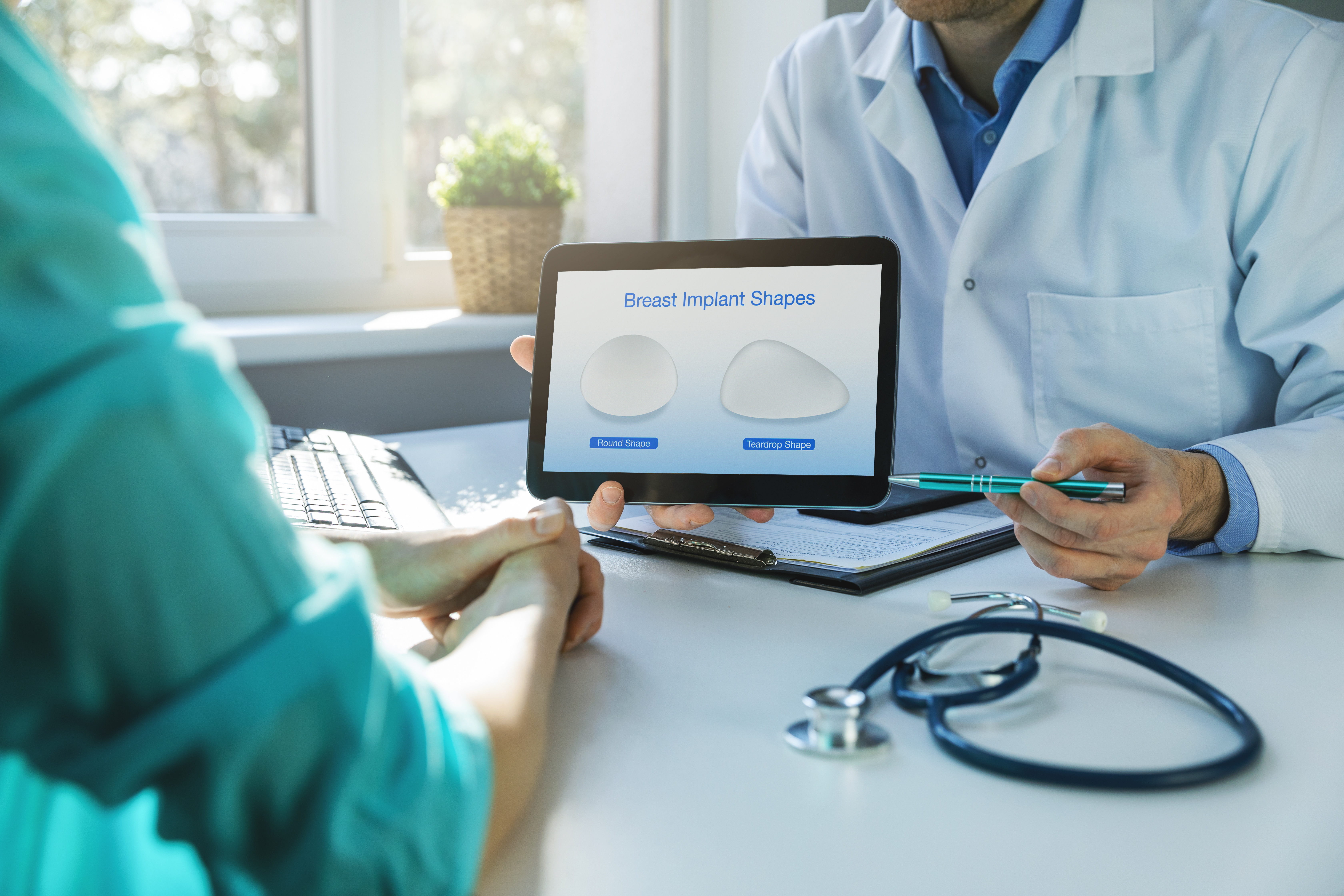 Doctor showing patient the different shape of an implant