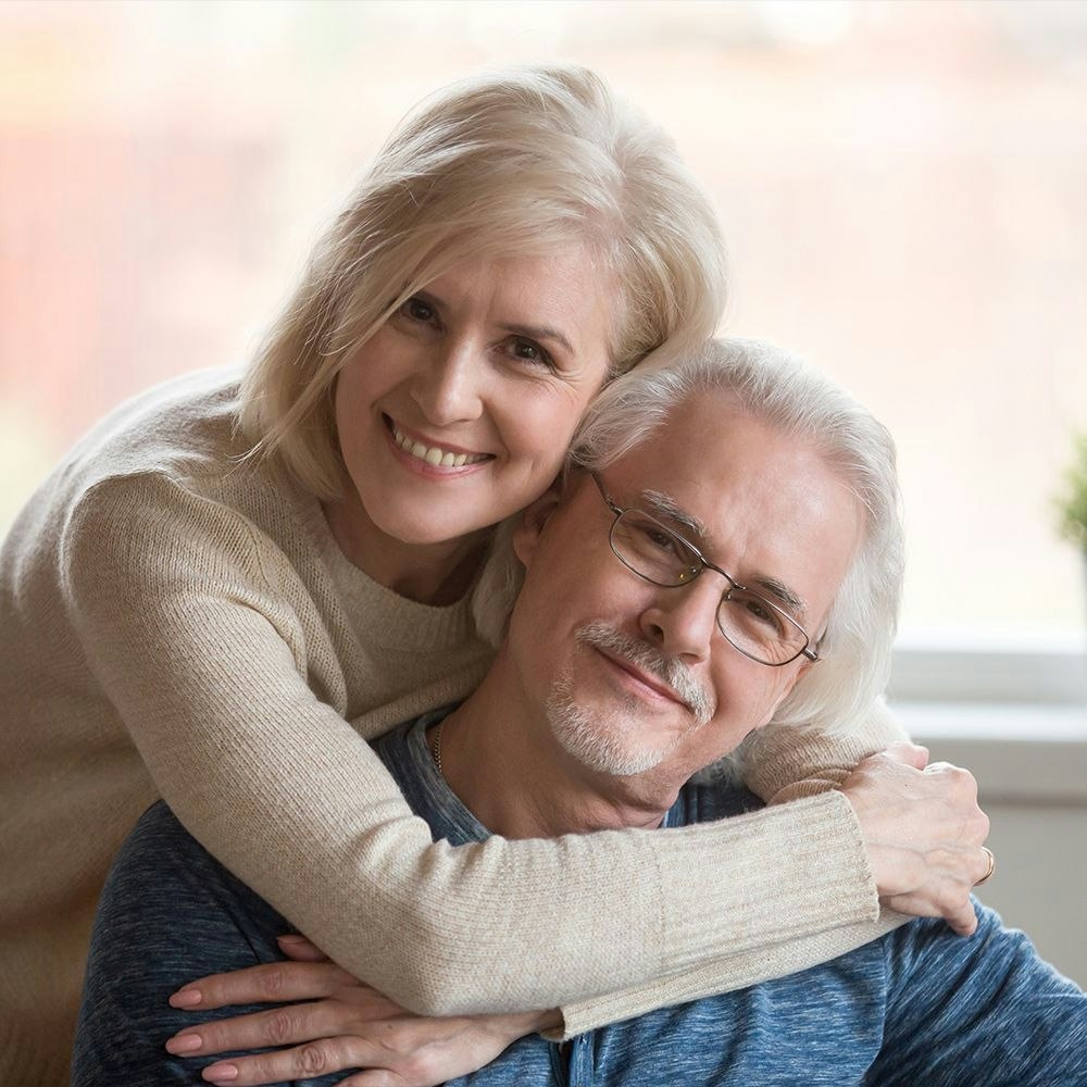 Senior couple laughing and hugging