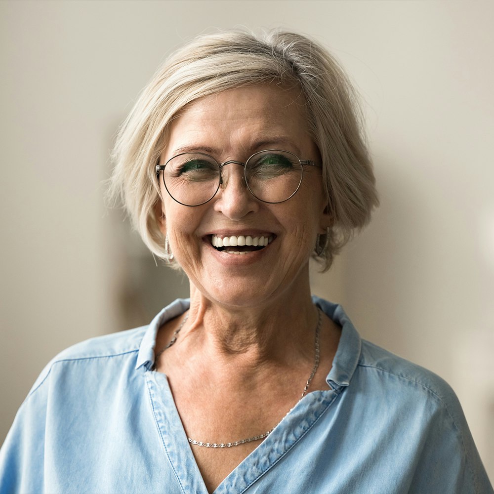 Smiling senior woman with dental implants