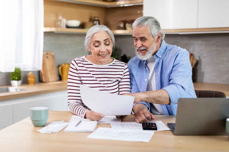 Mature couple looking at insurance together