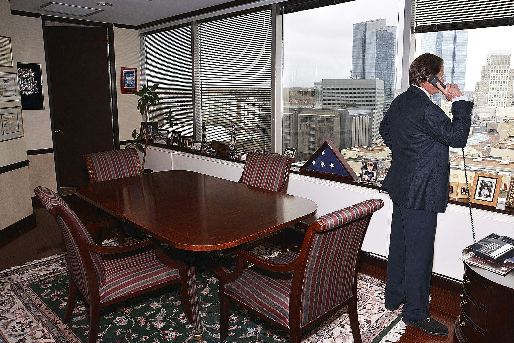Lawyer talking to client while looking outside office