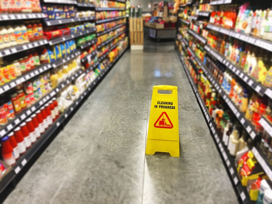 wet floor sign in grocery aisle
