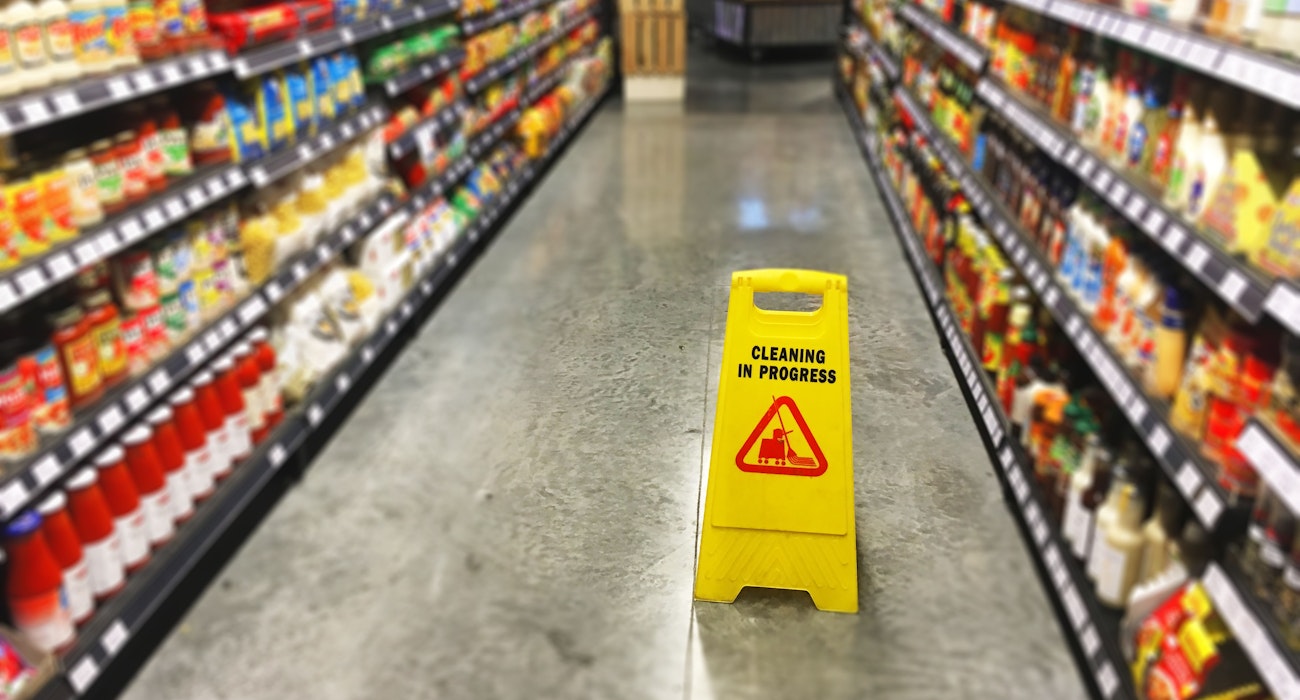 wet floor sign in grocery aisle