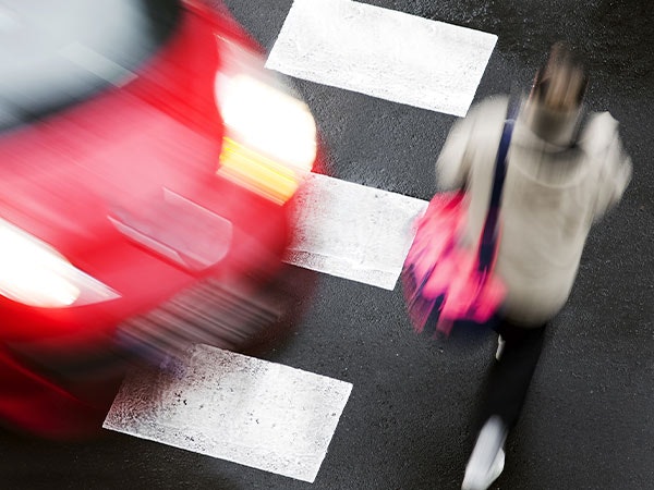 Car near pedestrian in crosswalk