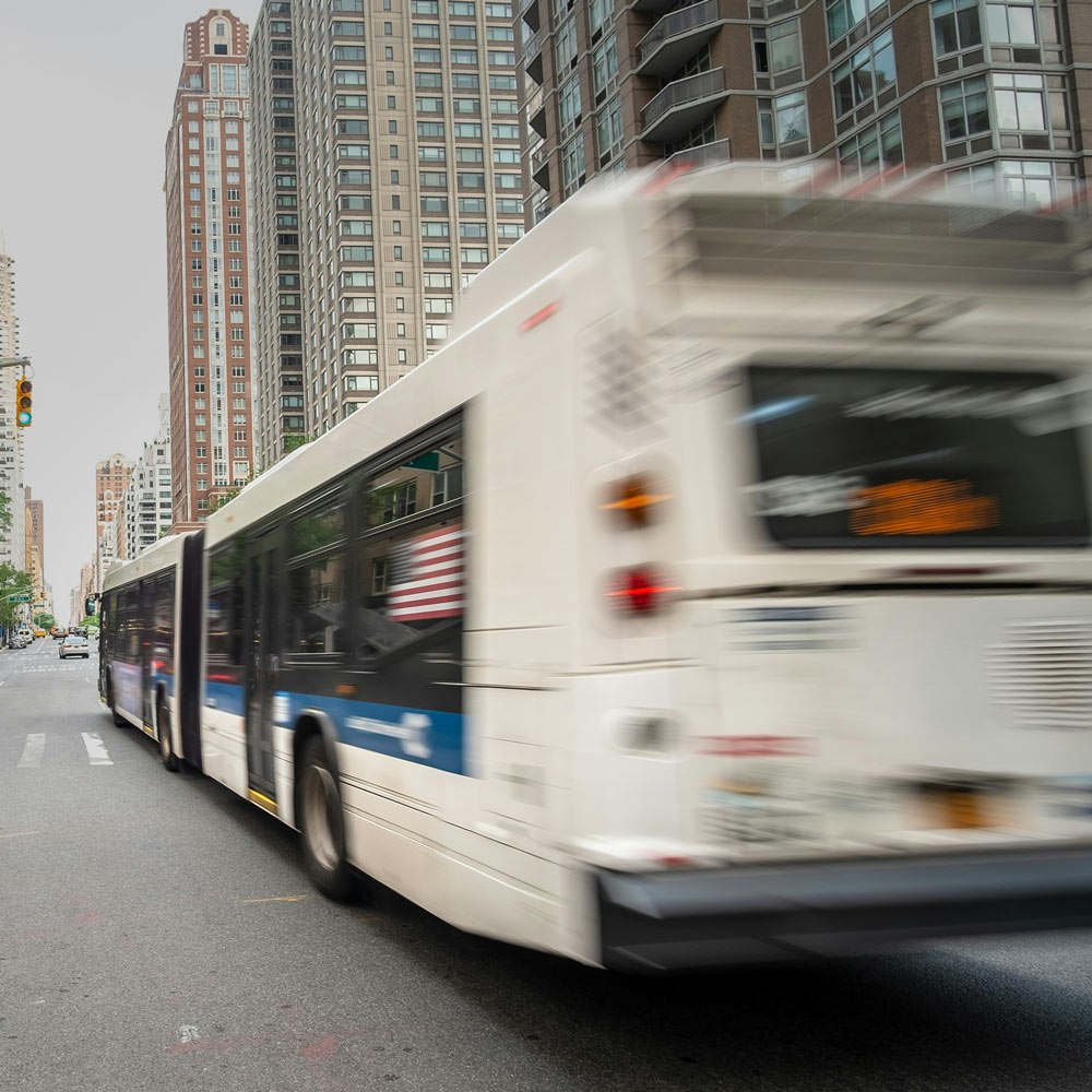 New York white bus speeding by