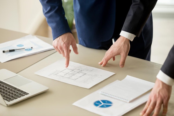 lawyers and economic expert going over data