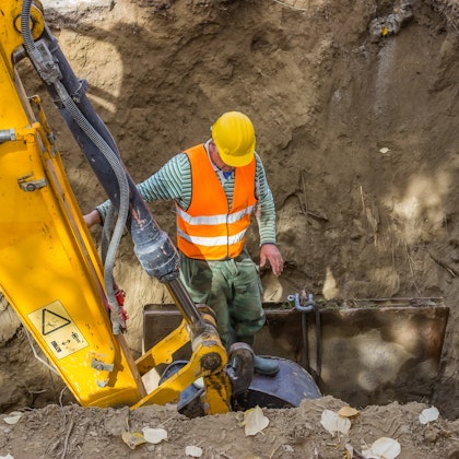 Construction worker near heavy machinery