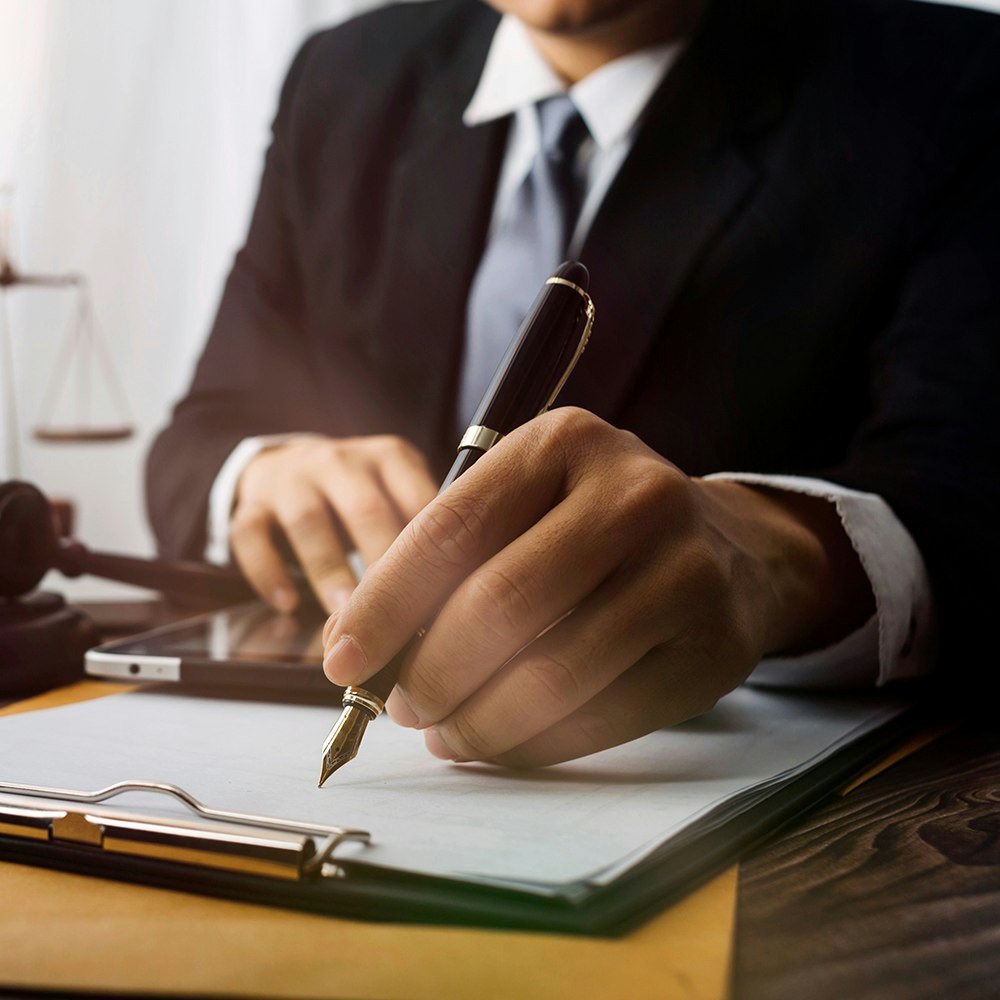 a hand signing a contact