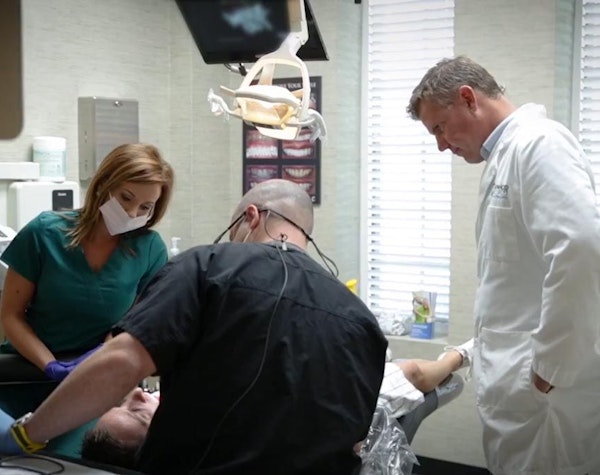 Dentists checking patient's teeth during veneers procedure