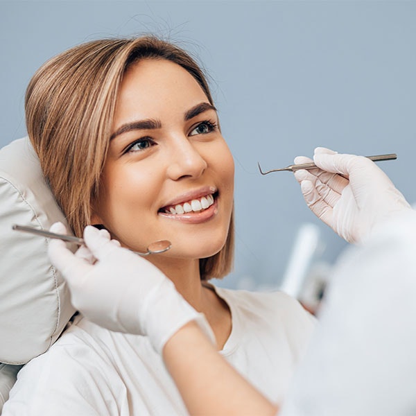 Young woman smiling in dental chair