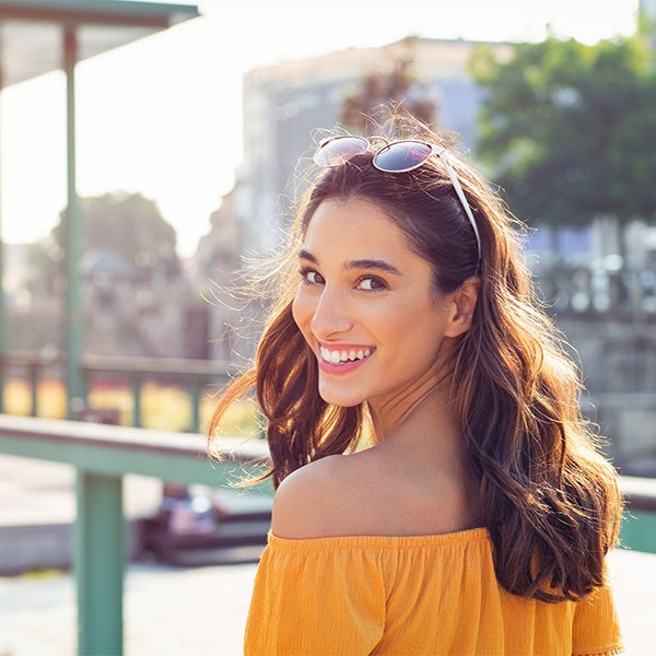 Young woman smiling while walking outside